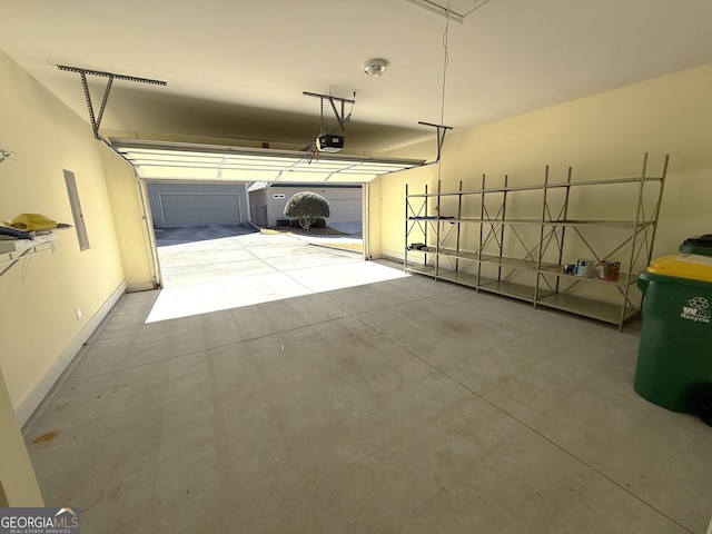 garage featuring a garage door opener and baseboards