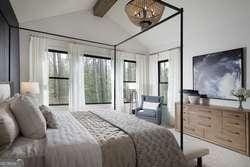 bedroom with vaulted ceiling with beams