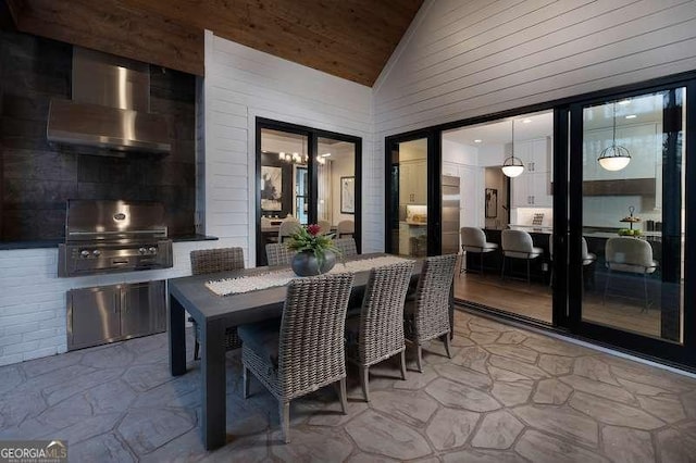 view of patio / terrace featuring outdoor dining space, exterior kitchen, and area for grilling