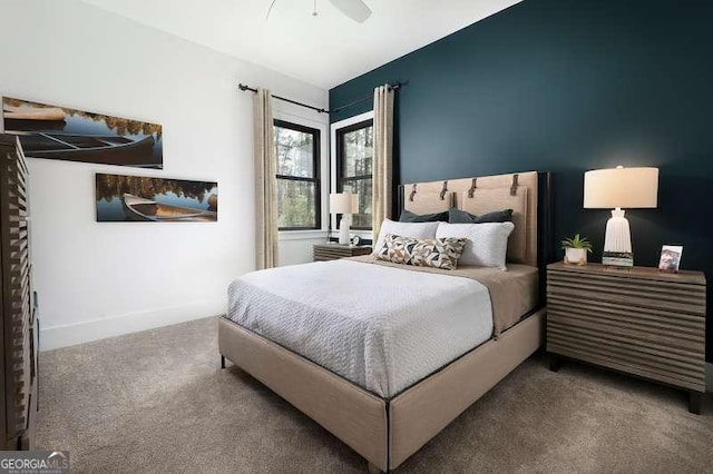 carpeted bedroom featuring a ceiling fan and baseboards
