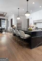 bar with decorative light fixtures, recessed lighting, and light wood finished floors