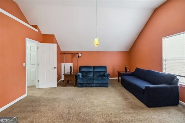 carpeted living area with baseboards and vaulted ceiling