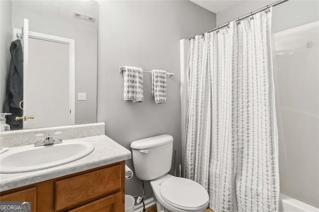 bathroom featuring toilet and vanity