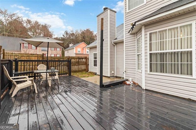 wooden deck featuring a residential view and fence