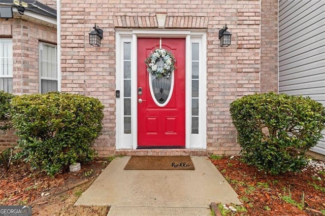 property entrance featuring brick siding