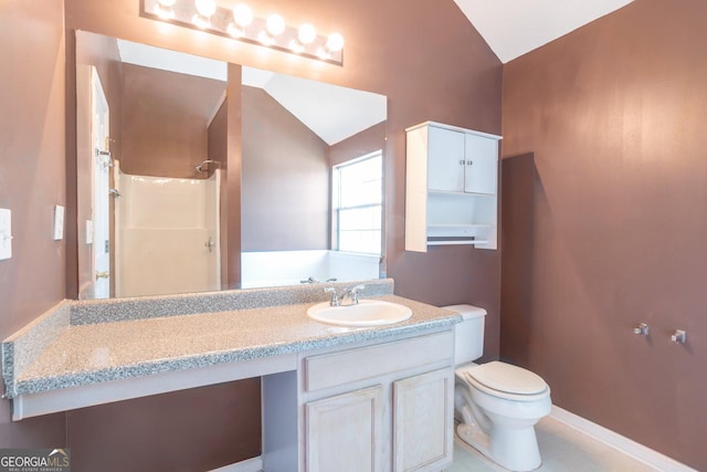 bathroom with a shower, vanity, lofted ceiling, toilet, and baseboards