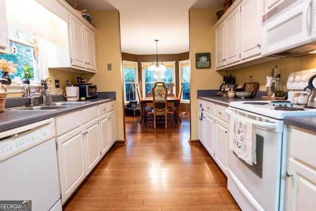 1041 Oconee Forest Ln, Watkinsville, GA 30677 - kitchen featuring white appliances, white cabinets, light wood finished floors, a sink, and dark countertops