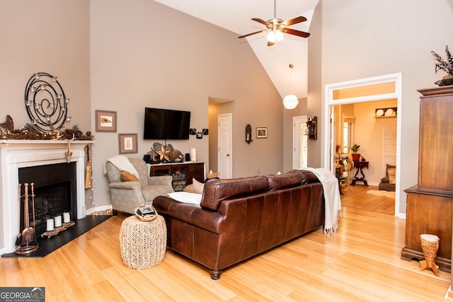 1041 Oconee Forest Ln, Watkinsville, GA 30677 - living area with high vaulted ceiling, a ceiling fan, light wood-style floors, a fireplace with flush hearth, and baseboards
