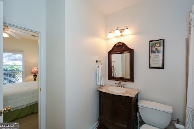 bathroom with ensuite bath, toilet, vanity, and ceiling fan