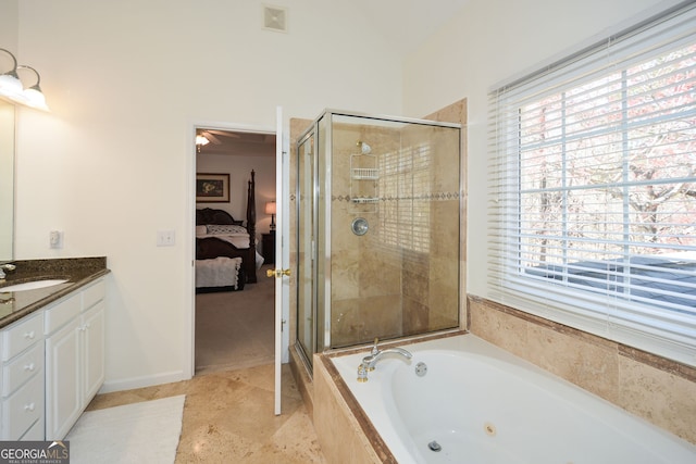ensuite bathroom featuring a shower stall, a jetted tub, vanity, and ensuite bathroom