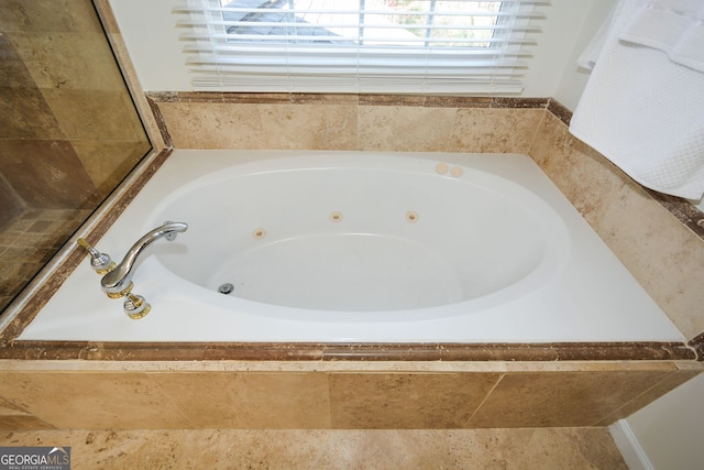 full bathroom featuring a jetted tub
