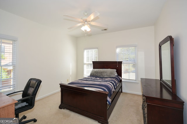 bedroom featuring visible vents, light carpet, baseboards, and a ceiling fan