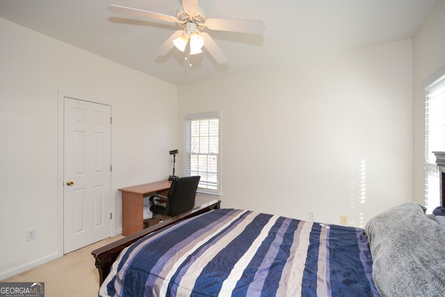 carpeted bedroom with baseboards and ceiling fan