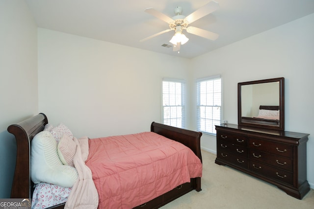 bedroom with light carpet, visible vents, and ceiling fan