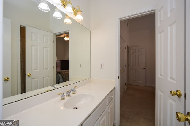 bathroom with ensuite bath, vanity, and ceiling fan
