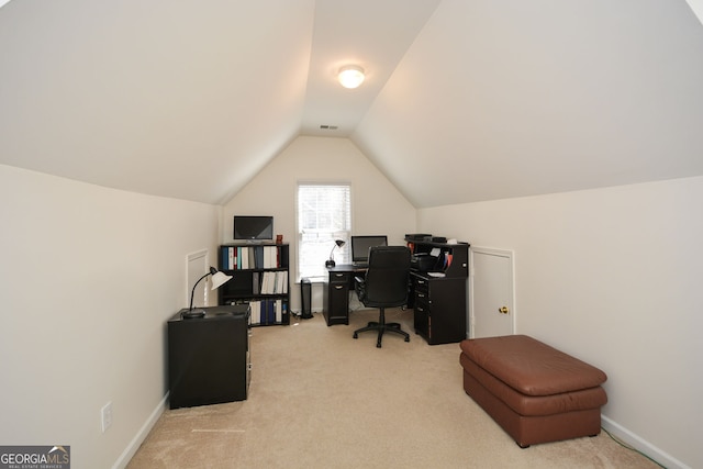 office space featuring visible vents, light carpet, baseboards, and vaulted ceiling