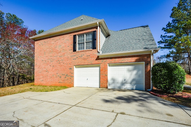 view of home's exterior featuring brick siding, concrete driveway, a shingled roof, and a garage