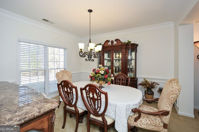dining space featuring a wainscoted wall, visible vents, crown molding, light colored carpet, and a chandelier