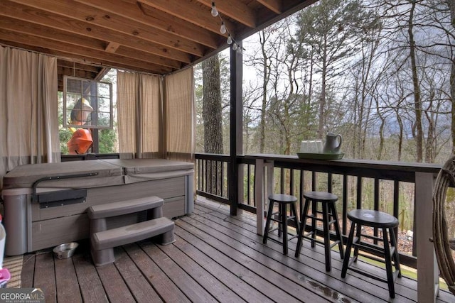 wooden terrace featuring a hot tub