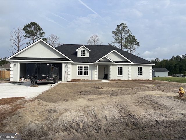 117 Rachel Way, Brunswick, GA 31523 - view of front of property with concrete driveway, an attached garage, stucco siding, and roof with shingles