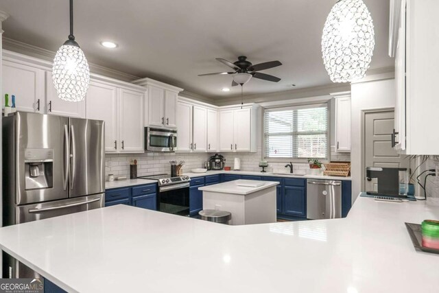 kitchen with blue cabinets, stainless steel appliances, white cabinets, light countertops, and ceiling fan