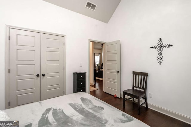 bedroom with baseboards, visible vents, high vaulted ceiling, dark wood finished floors, and a closet