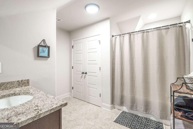 full bath with vanity, a shower with curtain, baseboards, and tile patterned flooring