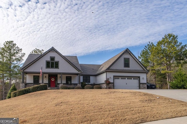 craftsman-style home with concrete driveway and stone siding
