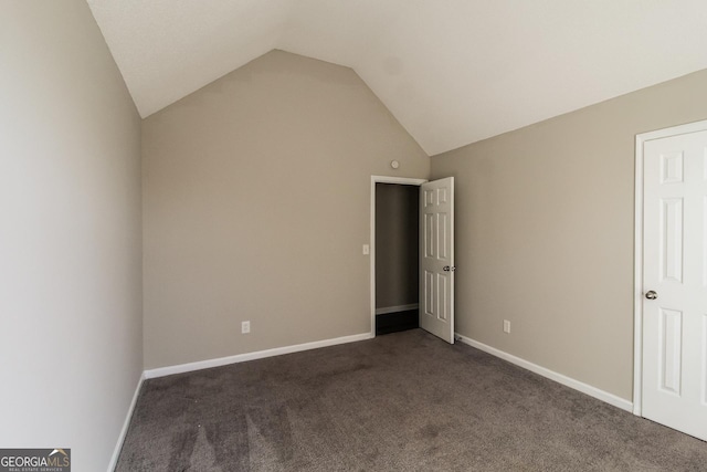 5345 Bridle Point Pkwy, Snellville, GA 30039 - unfurnished bedroom with baseboards, dark carpet, and vaulted ceiling