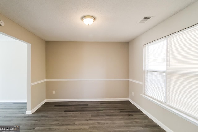 5345 Bridle Point Pkwy, Snellville, GA 30039 - spare room with dark wood-type flooring, a healthy amount of sunlight, and visible vents