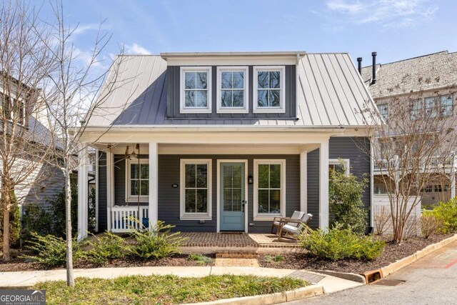 view of front of house featuring a standing seam roof, covered porch, and metal roof