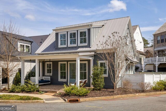 view of front of house featuring metal roof and covered porch