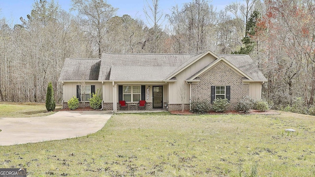 2359 S Walkers Mill Rd, Griffin, GA 30224 - ranch-style house with board and batten siding, a shingled roof, a front lawn, and a view of trees