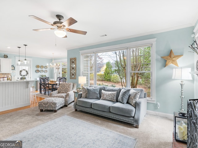 living area with visible vents, baseboards, light colored carpet, and crown molding