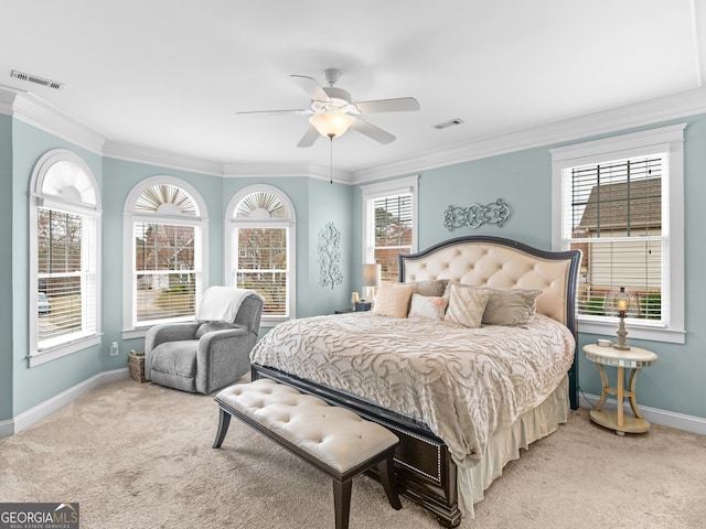 carpeted bedroom with visible vents, crown molding, and baseboards