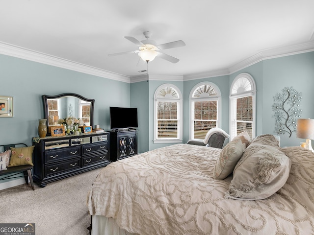 bedroom with visible vents, ceiling fan, crown molding, and carpet