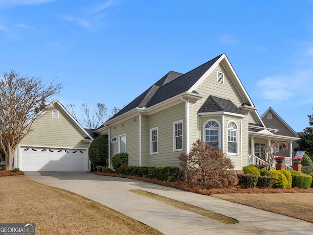 view of front of home featuring covered porch, driveway, and a shingled roof