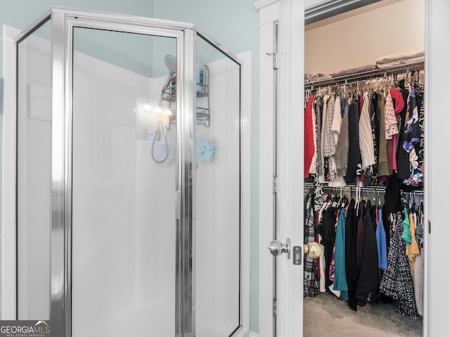 full bath featuring a spacious closet and a stall shower