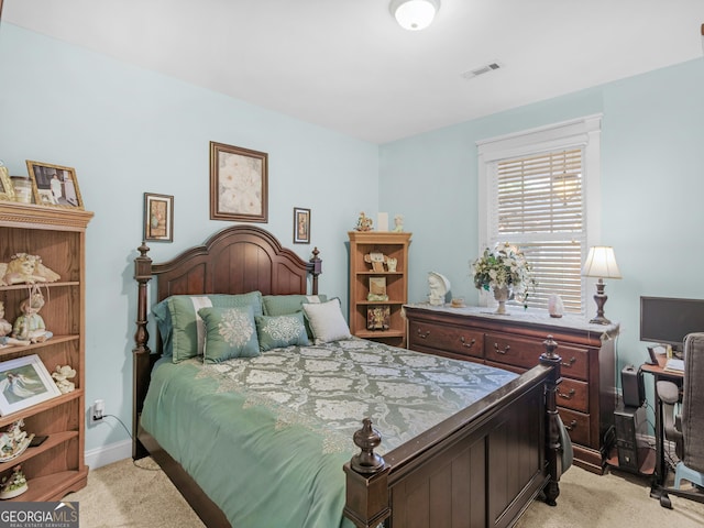 bedroom featuring baseboards and light carpet