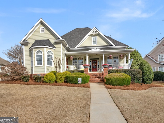 view of front of property featuring roof with shingles and a porch