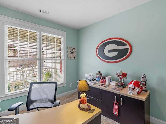 office area featuring visible vents, baseboards, and carpet