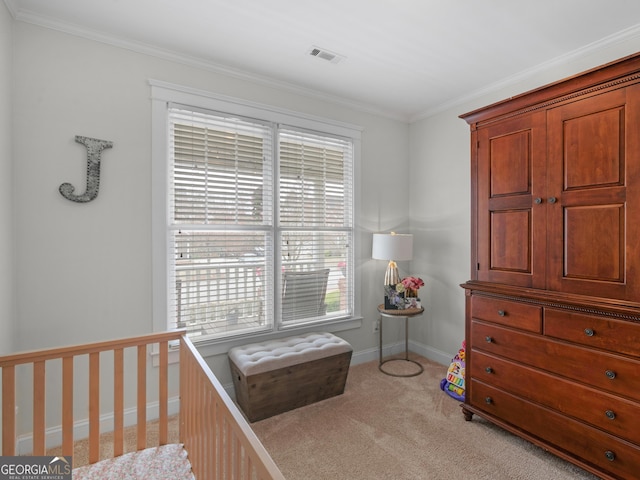 carpeted bedroom with visible vents, baseboards, and ornamental molding