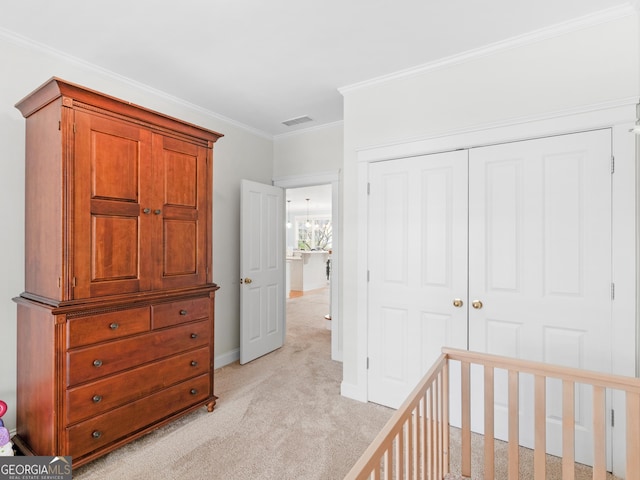 bedroom featuring visible vents, light carpet, ornamental molding, a closet, and baseboards