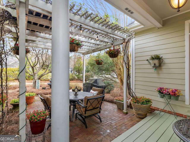 view of patio featuring outdoor dining area, a pergola, and a grill