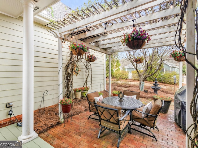 view of patio / terrace featuring a pergola and outdoor dining area