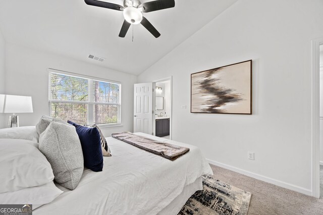 bedroom featuring visible vents, connected bathroom, carpet, baseboards, and vaulted ceiling