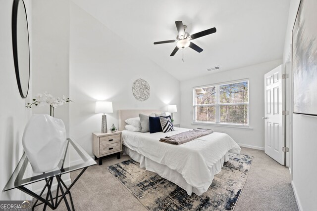 bedroom featuring a ceiling fan, baseboards, visible vents, carpet floors, and lofted ceiling