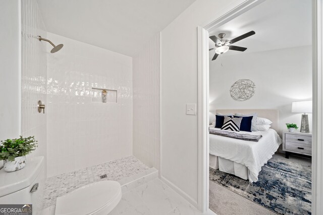 full bath with toilet, tiled shower, ensuite bathroom, marble finish floor, and a ceiling fan
