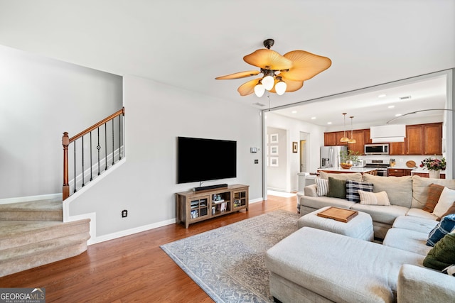3810 Branch Bluff Ln, Cumming, GA 30040 - living room featuring a ceiling fan, wood finished floors, recessed lighting, stairway, and baseboards