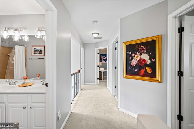 3810 Branch Bluff Ln, Cumming, GA 30040 - hall with carpet flooring, baseboards, visible vents, and a sink